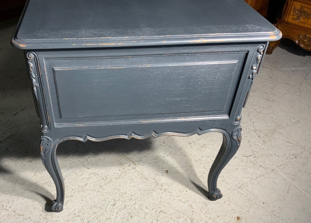A dark grey painted French oak desk featuring five carved drawers with brass drop handles, a carved apron, and cabriole legs. View VI
