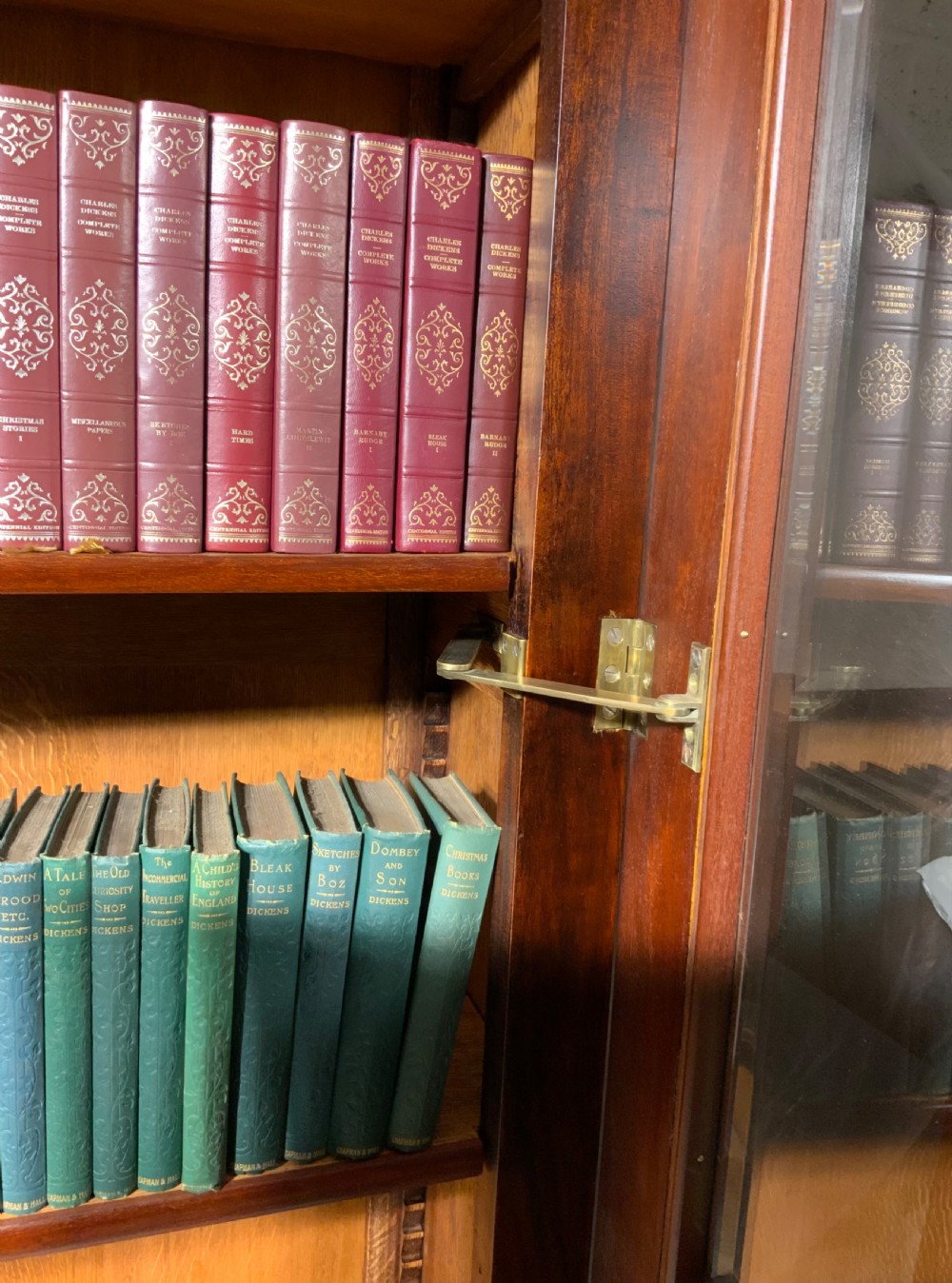 A tall French mahogany bookcase featuring two full-length glazed and panelled doors with turned feet. View XI
