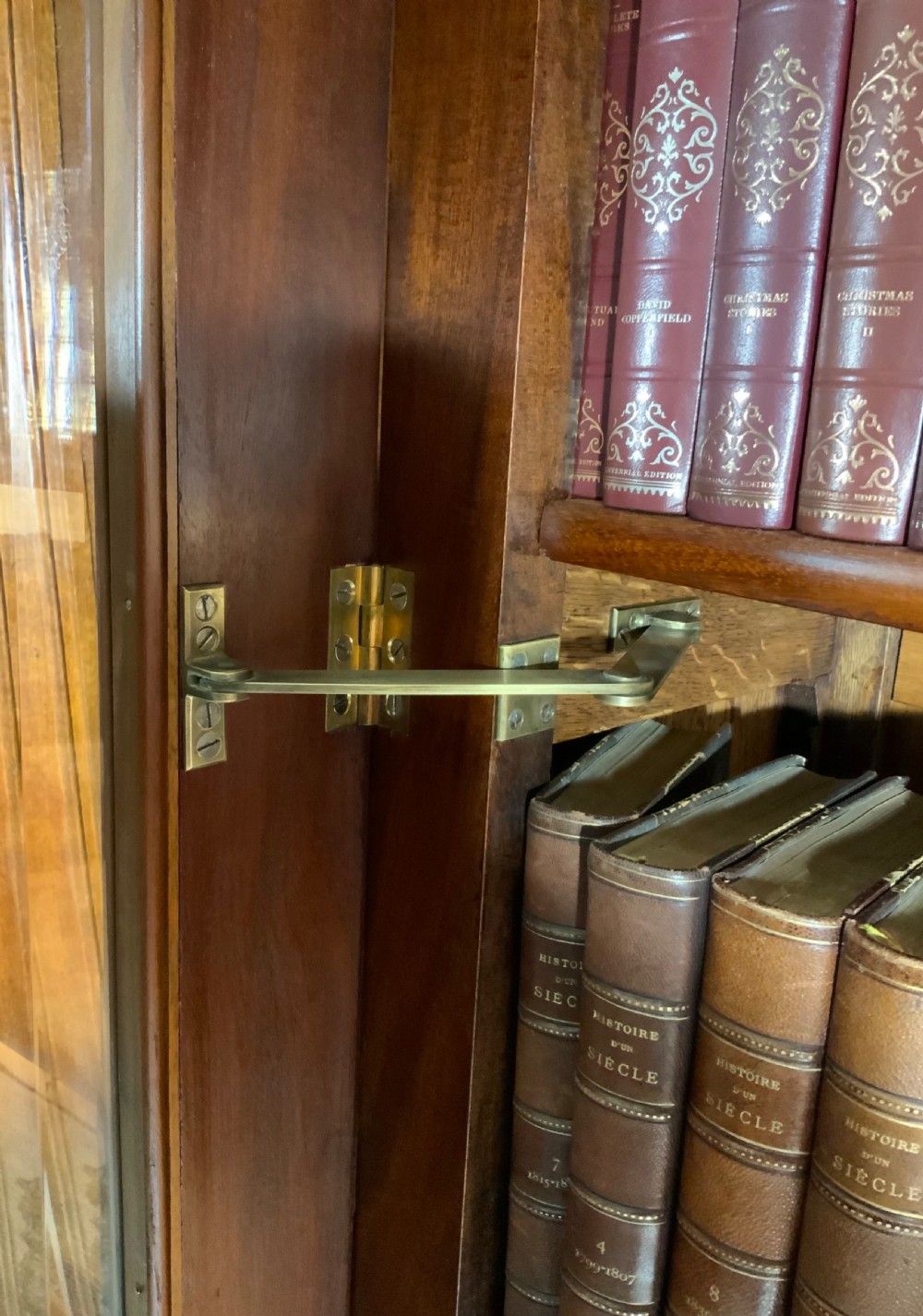 A tall French mahogany bookcase featuring two full-length glazed and panelled doors with turned feet. View XII