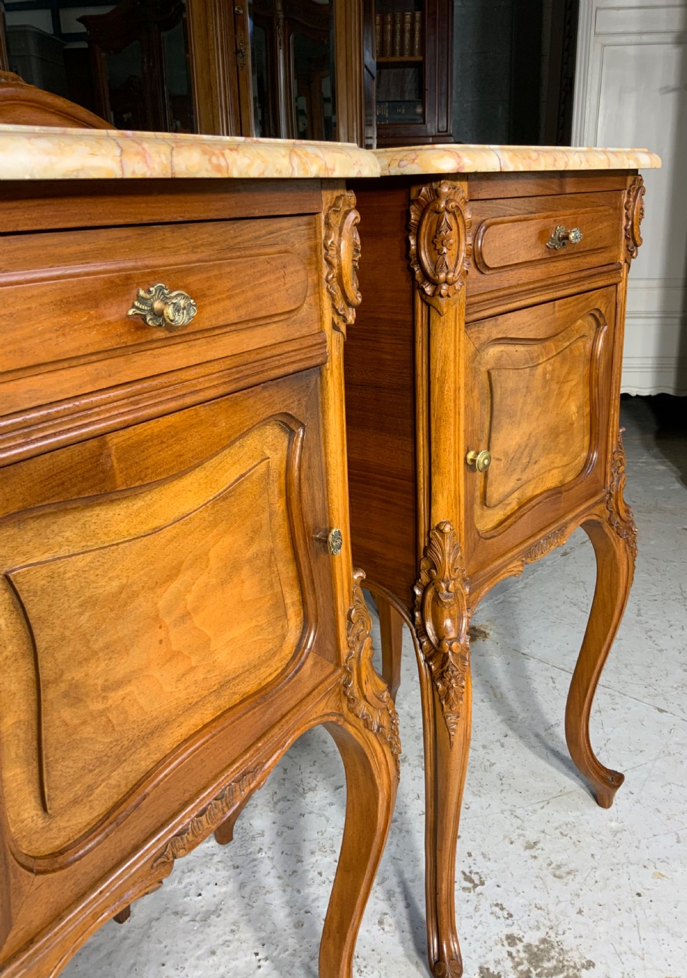 An ornate carved walnut French bed frame with a high headboard, shaped footboard, and two matching marble-topped bedside cabinets. View XXIV
