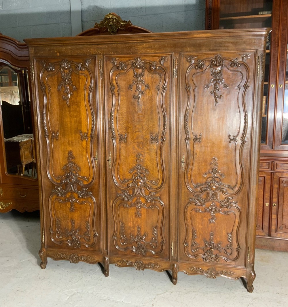 CARVED OAK TRIPLE ARMOIRE 