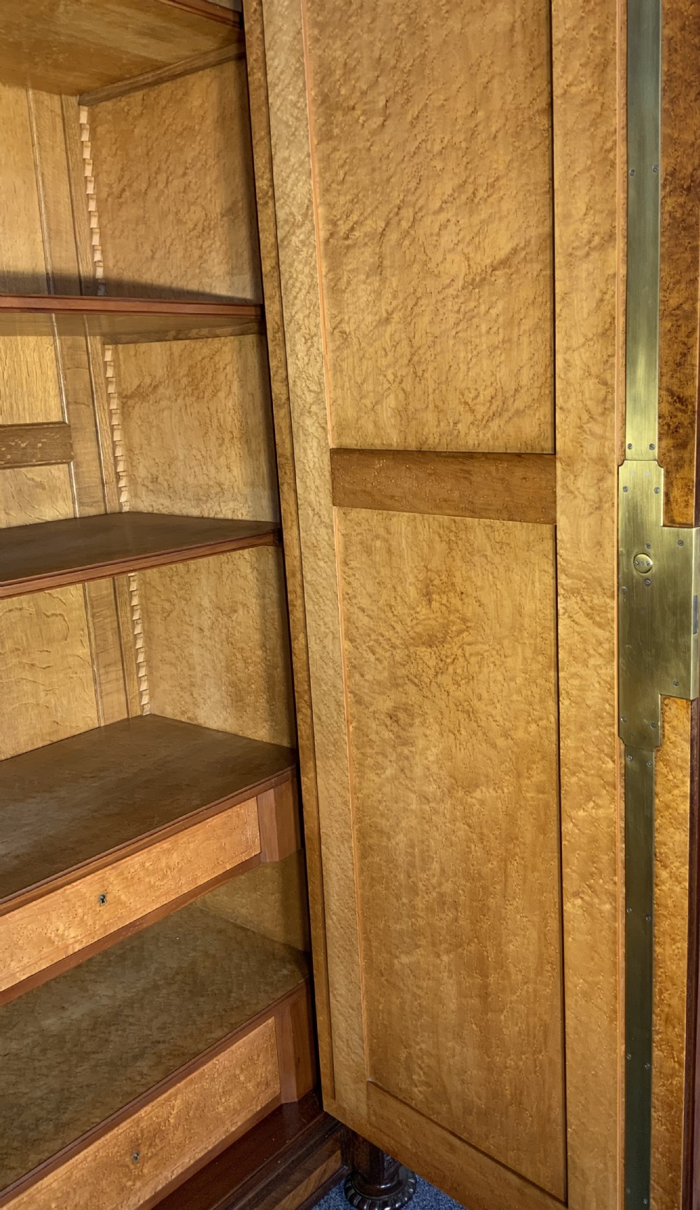 A tall 19th-century French rosewood armoire with two full-length mirrored doors, an arched pediment topped with a foliage crest carving, and fluted corner columns. View X