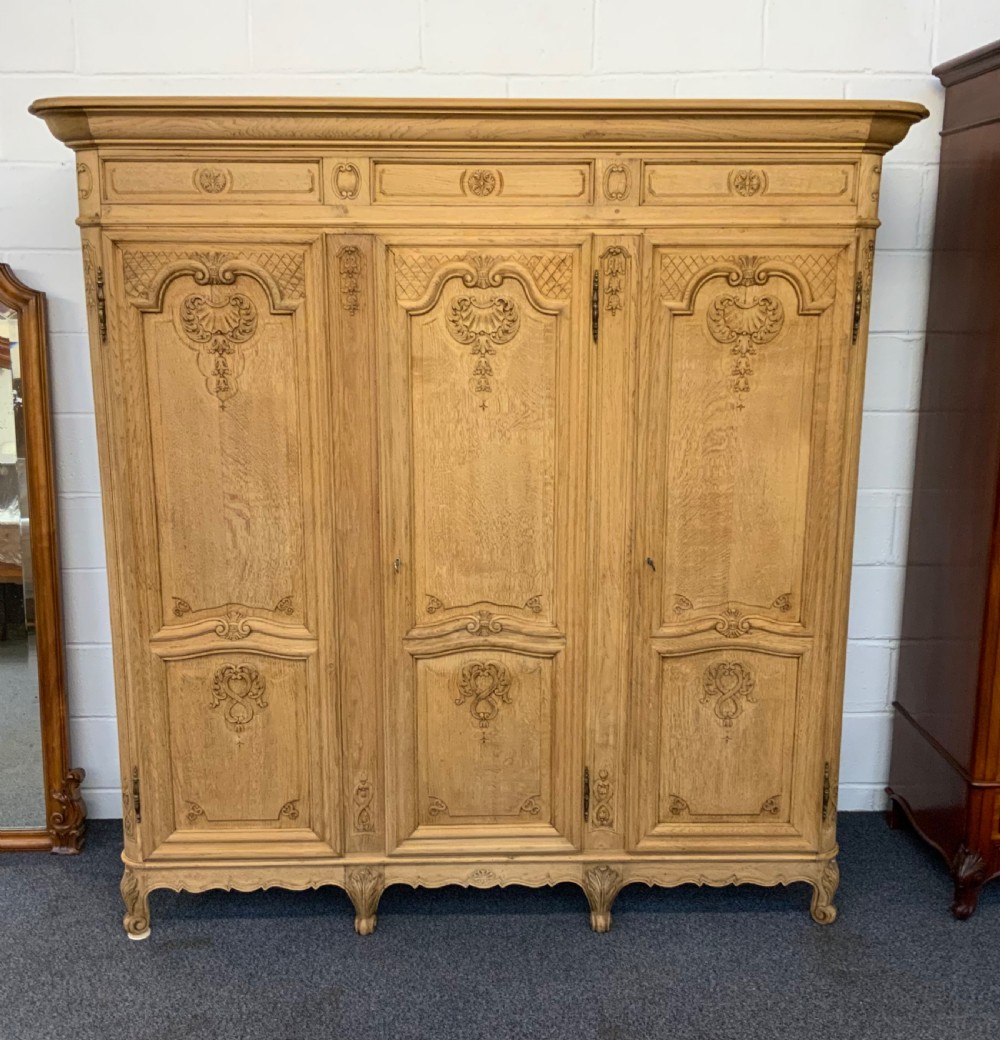 CARVED FRENCH OAK BLEACHED TRIPLE ARMOIRE 