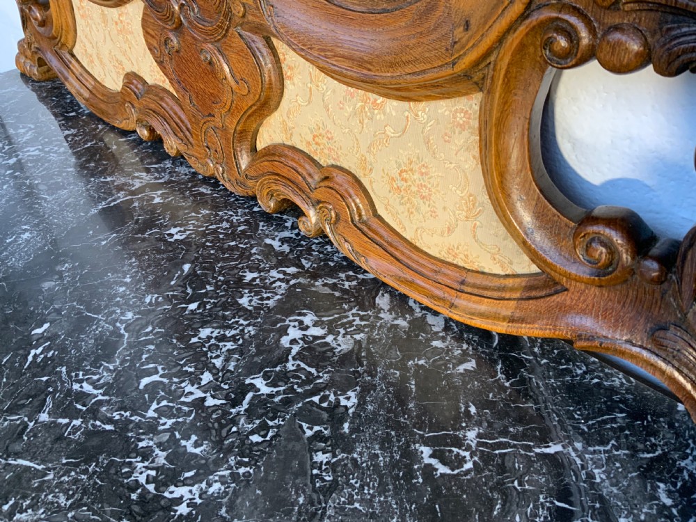 A carved oak dressing table featuring a black marble surface, an attached shaped mirror frame, four drawers with metal handles, and cabriole legs. View VIII