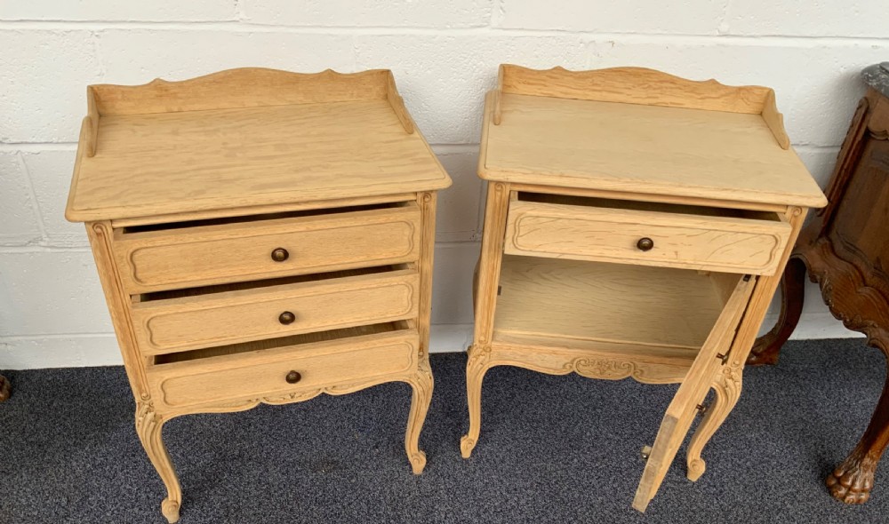 A matching pair of bleached oak French bedside cabinets featuring three drawers, carved aprons, cabriole legs, and gallery tops. View V