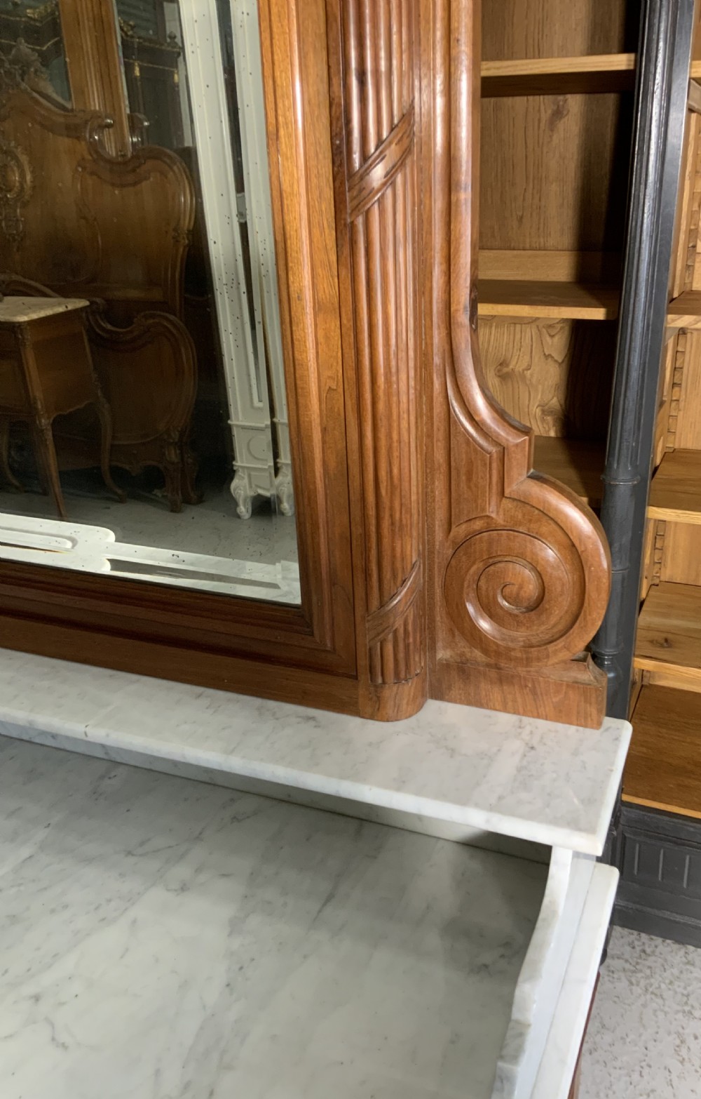 An antique mahogany French washstand featuring a white marble top, integrated arched mirror, multiple drawers, and side cupboards with brass handles. View IX