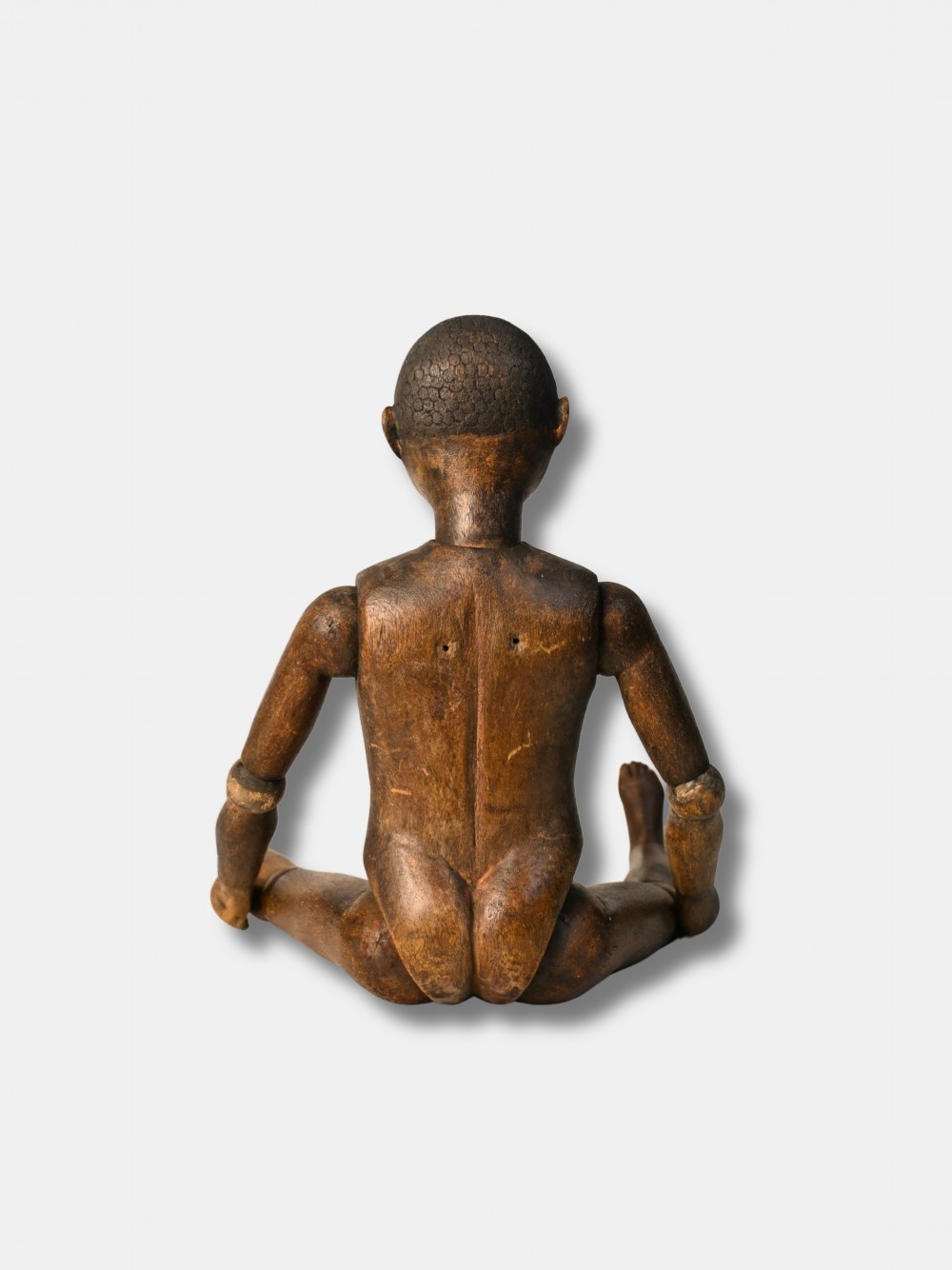 A carved dark wood articulated lay figure standing upright with jointed limbs. View IV