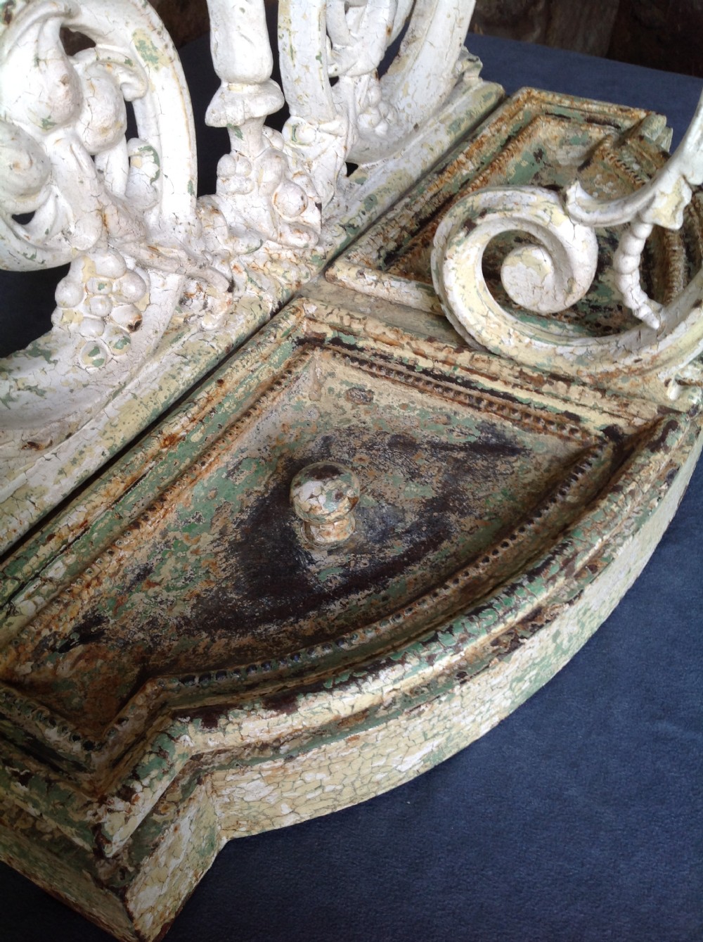 An ornate off-white painted Victorian cast iron umbrella stand with botanical scrollwork and a twin drip tray base. View X