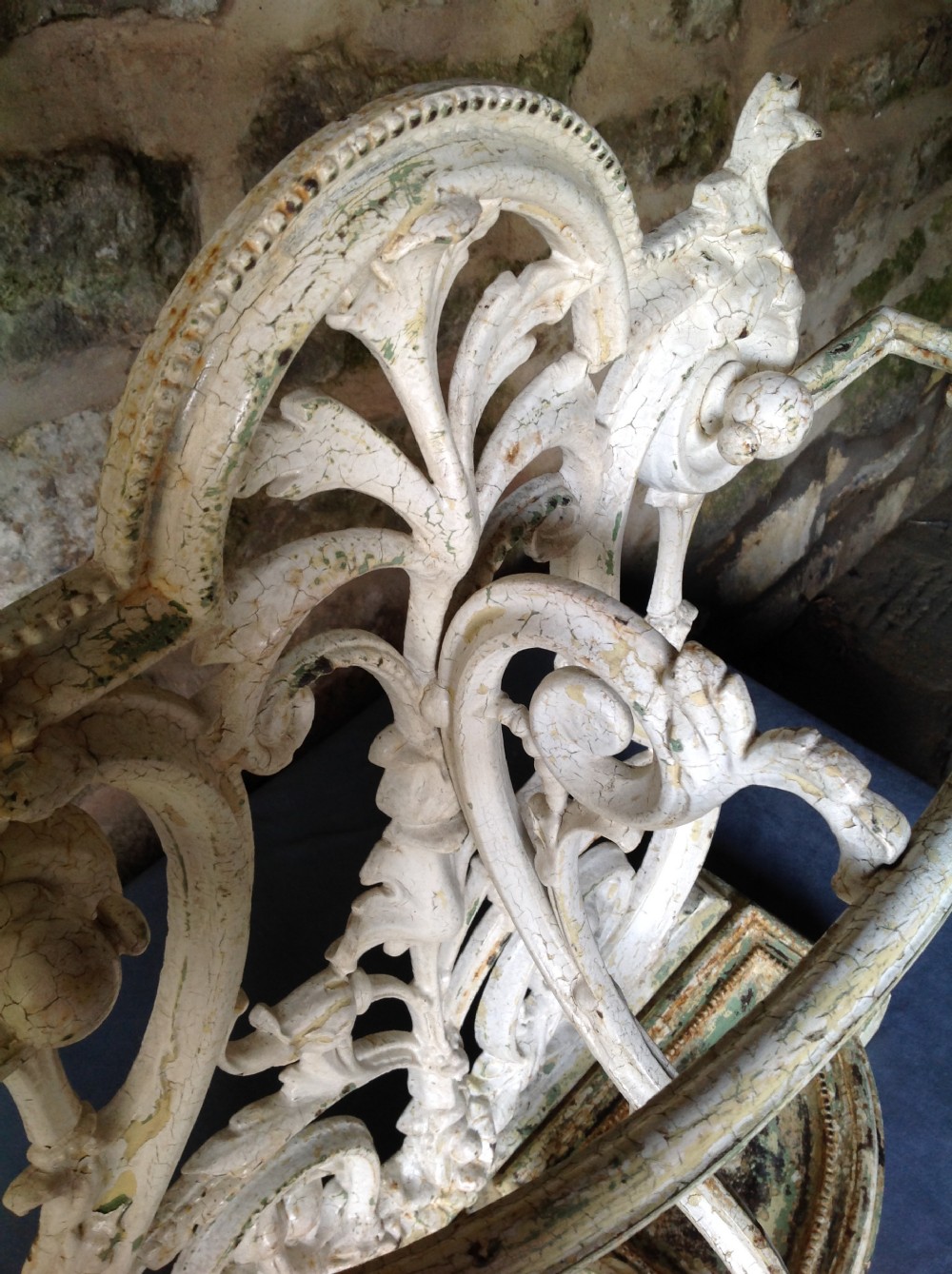An ornate off-white painted Victorian cast iron umbrella stand with botanical scrollwork and a twin drip tray base. View XIV