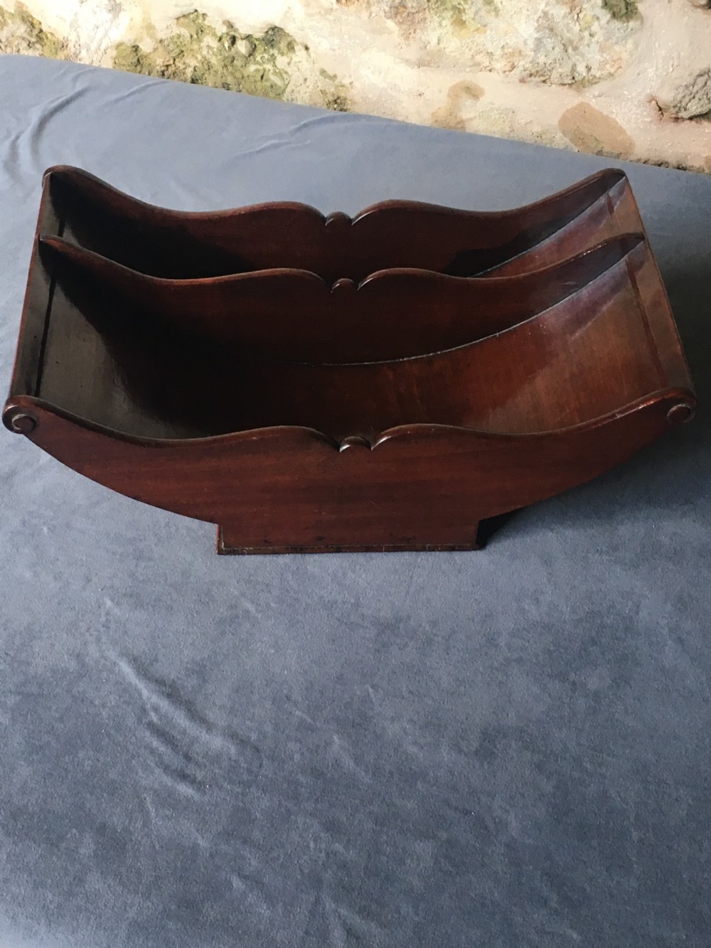 A dark mahogany Georgian cheese coaster featuring a crescent-shaped body with a central divider and scrolled ends set upon a rectangular base. View II