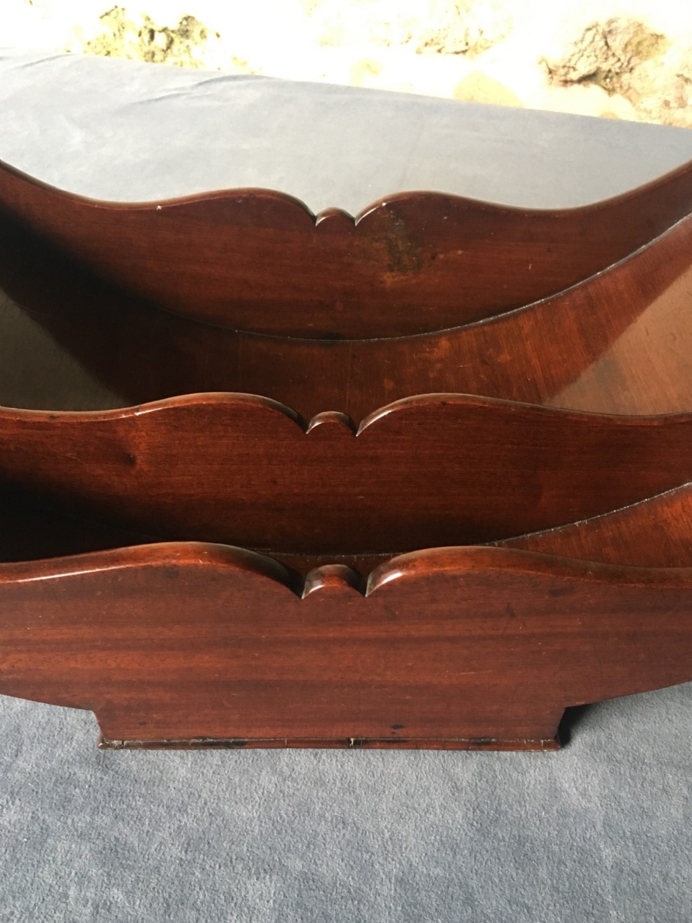 A dark mahogany Georgian cheese coaster featuring a crescent-shaped body with a central divider and scrolled ends set upon a rectangular base. View XI