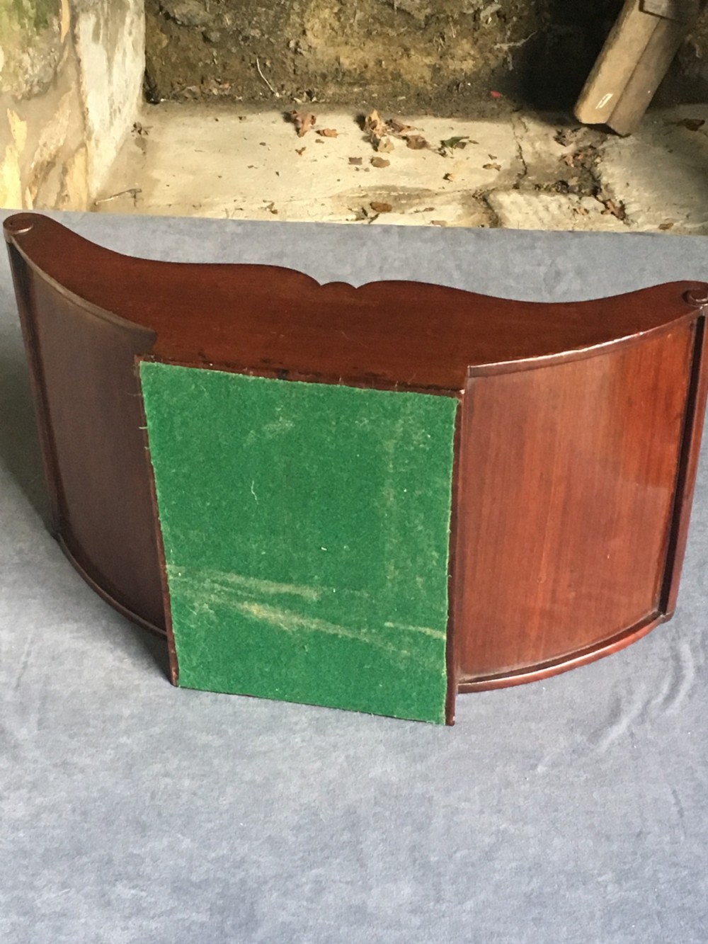 A dark mahogany Georgian cheese coaster featuring a crescent-shaped body with a central divider and scrolled ends set upon a rectangular base. View XIII