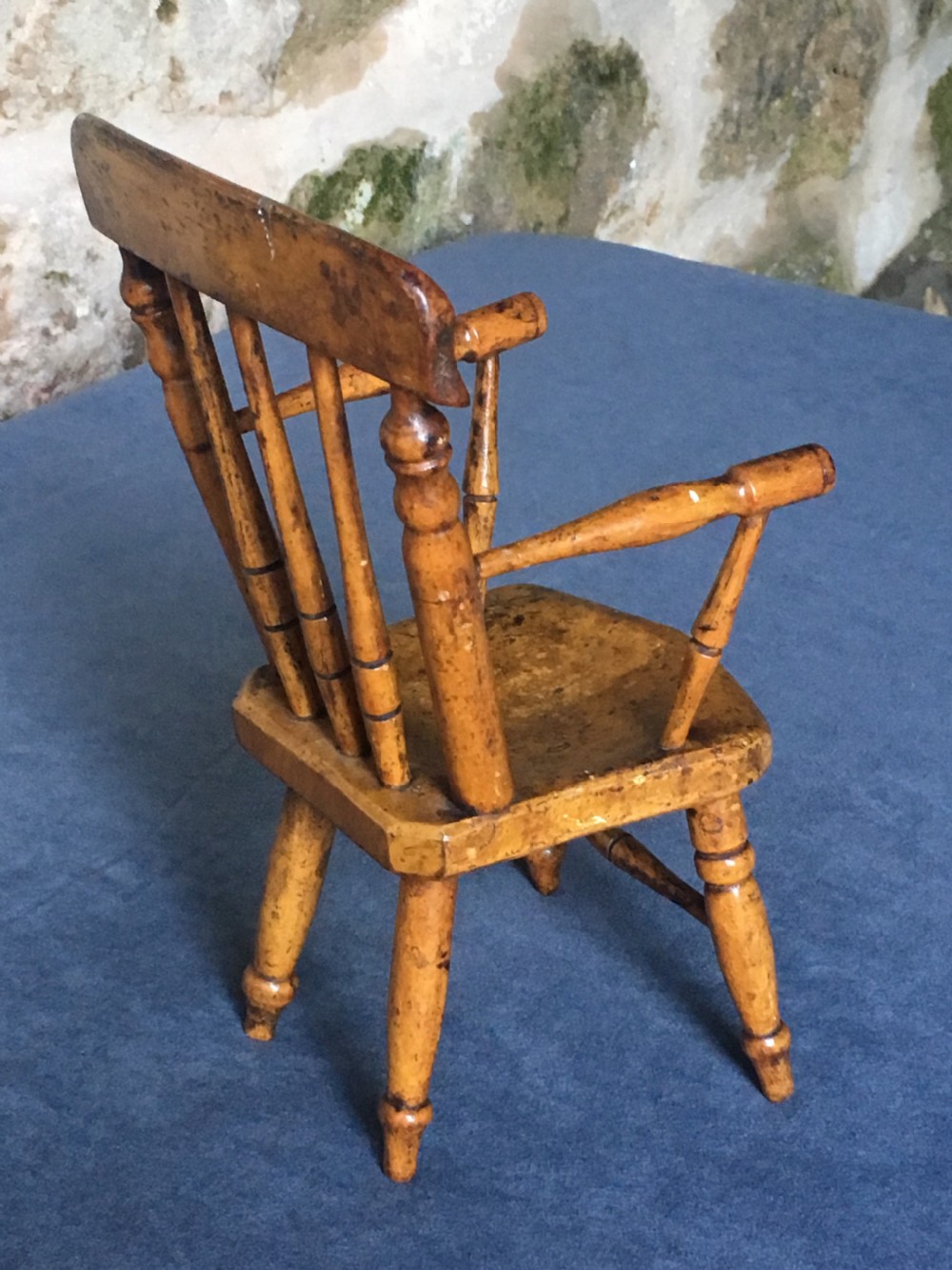 A wooden miniature Windsor armchair featuring turned spindle back supports, curved armrests, and turned legs. View VIII