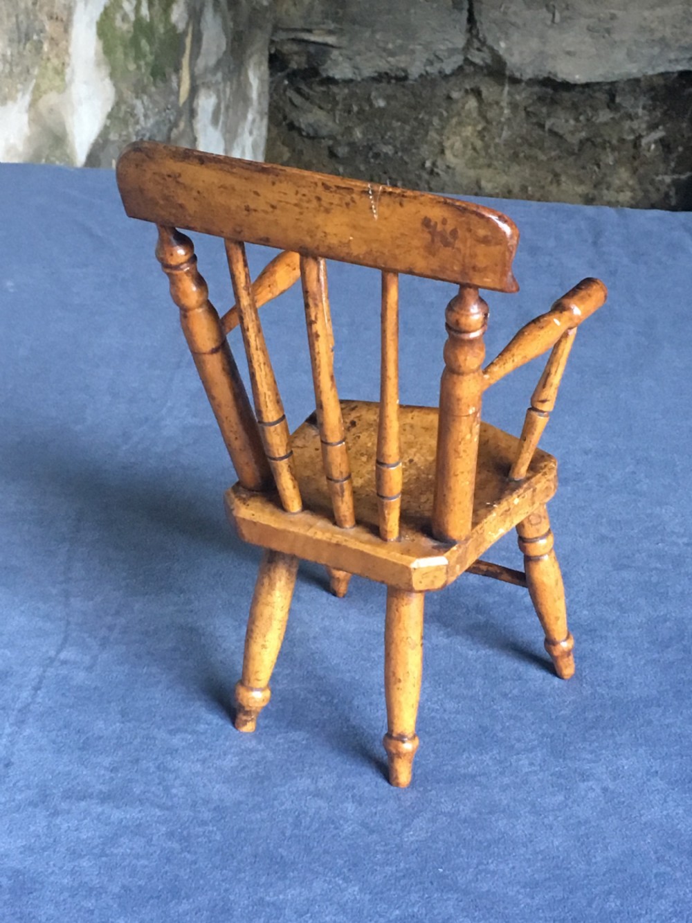 A wooden miniature Windsor armchair featuring turned spindle back supports, curved armrests, and turned legs. View IX
