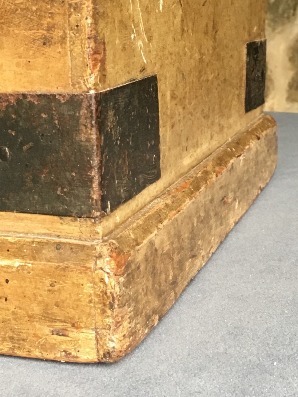 A small Victorian wooden trunk featuring an ochre painted finish, dark iron corner brackets, side handles, and a hinged lid. View VIII