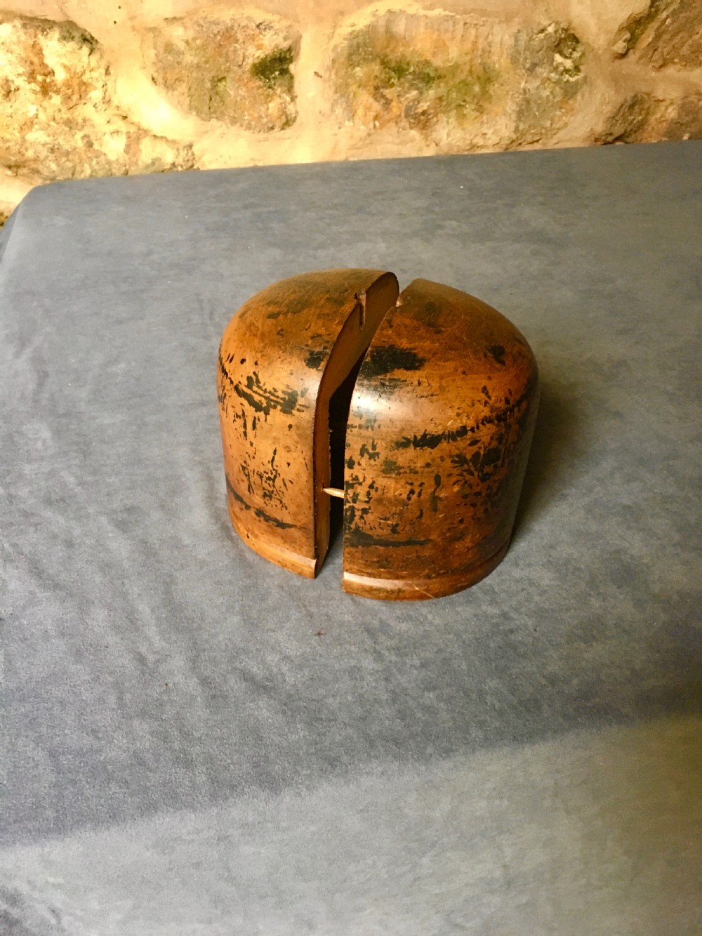 A two-piece carved wooden milliners hat block featuring a rounded dome top and a weathered brown and black painted finish. View III