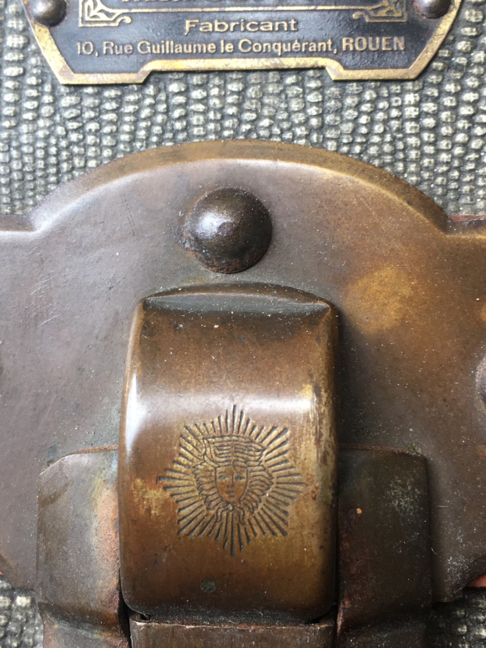 An antique French hard-sided luggage suitcase featuring grey canvas, tan leather trim, brass hardware, and a leather carrying handle. View XXVII