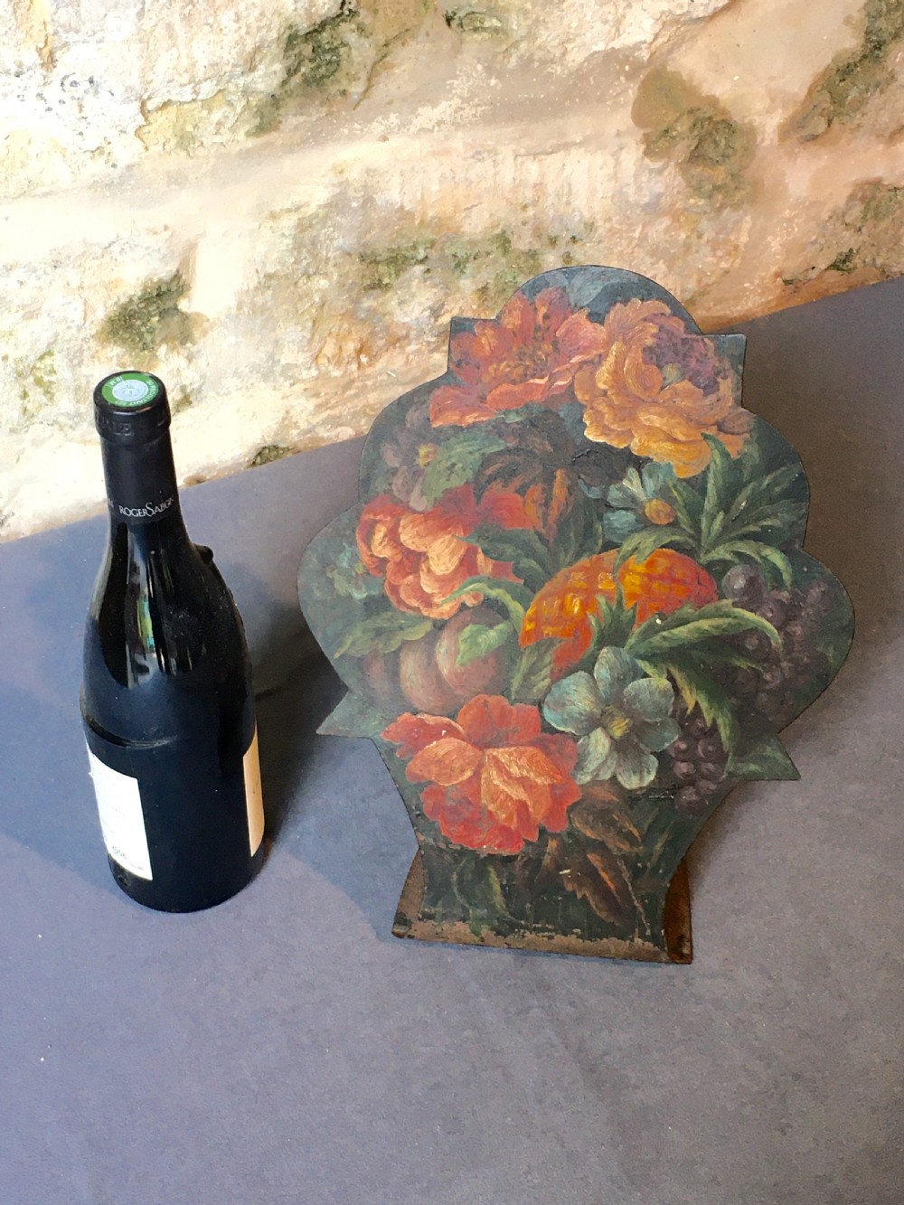 A contoured painted sheet metal stand depicting a botanical floral and fruit still life arrangement. View III