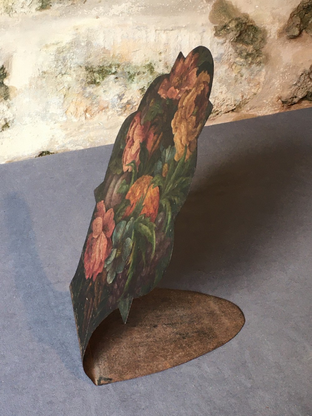 A contoured painted sheet metal stand depicting a botanical floral and fruit still life arrangement. View X