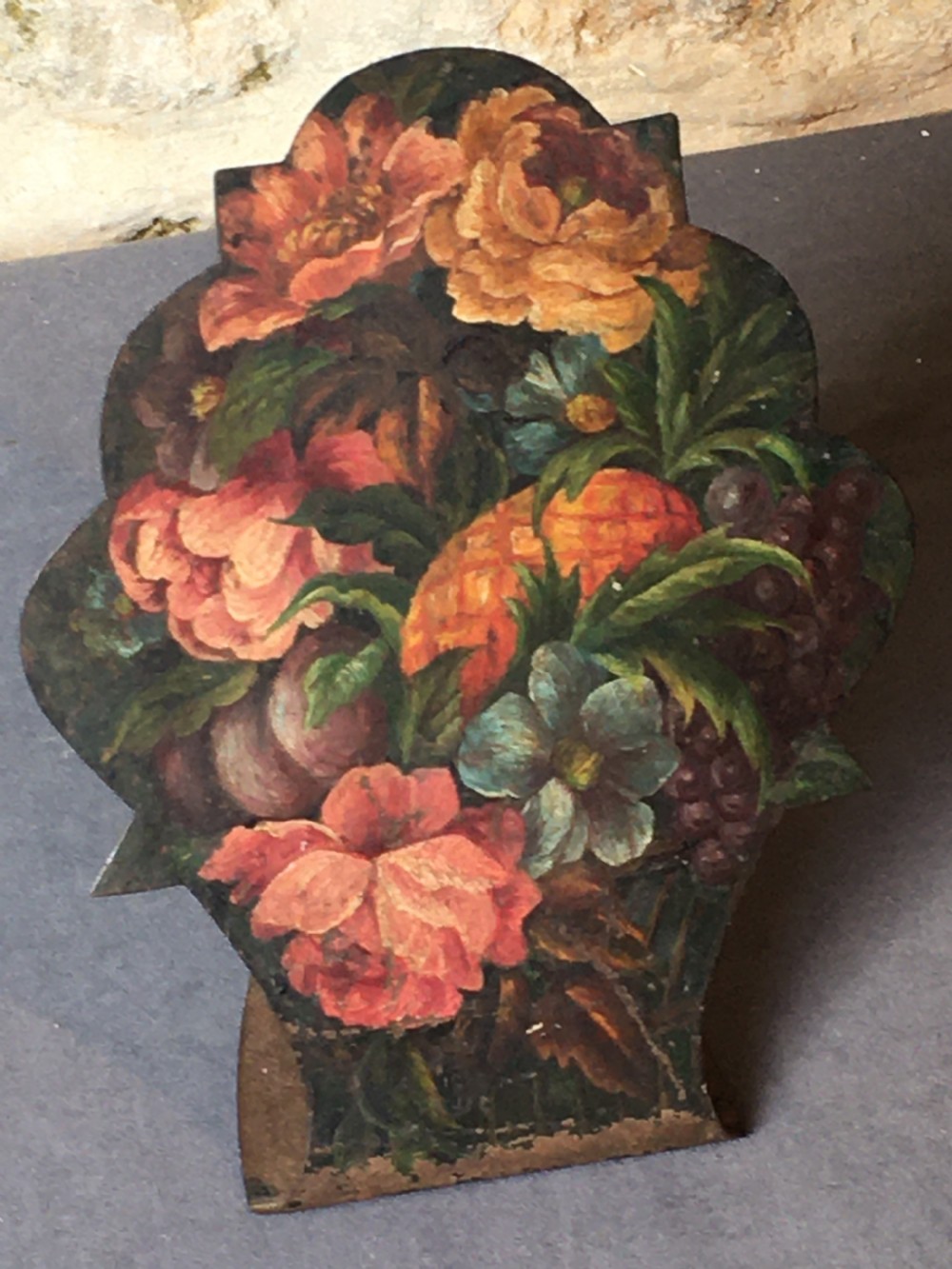 A contoured painted sheet metal stand depicting a botanical floral and fruit still life arrangement. View XIII