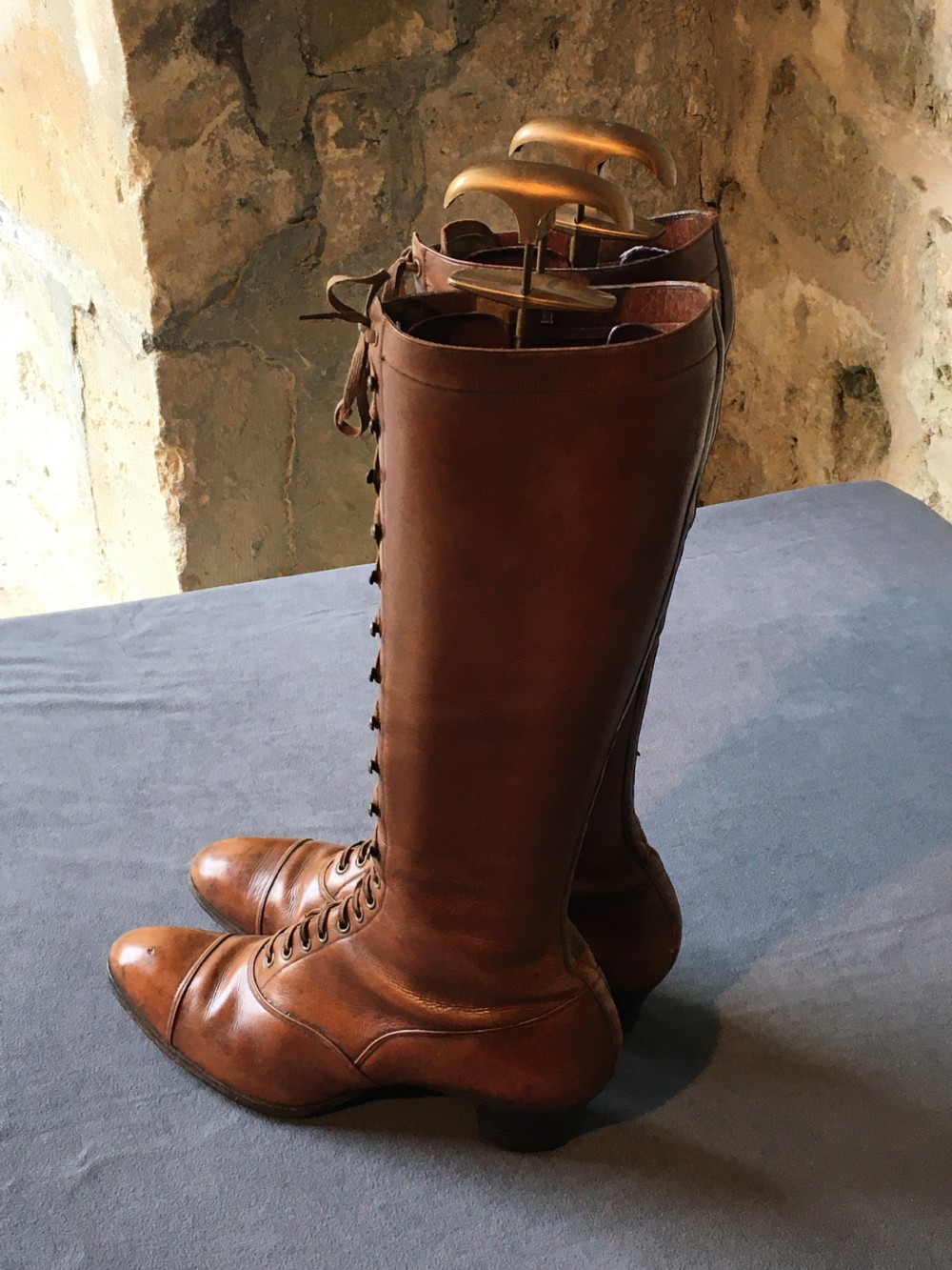 A pair of antique tall brown leather lace-up boots fitted with metal and brass boot shapers. View XIII