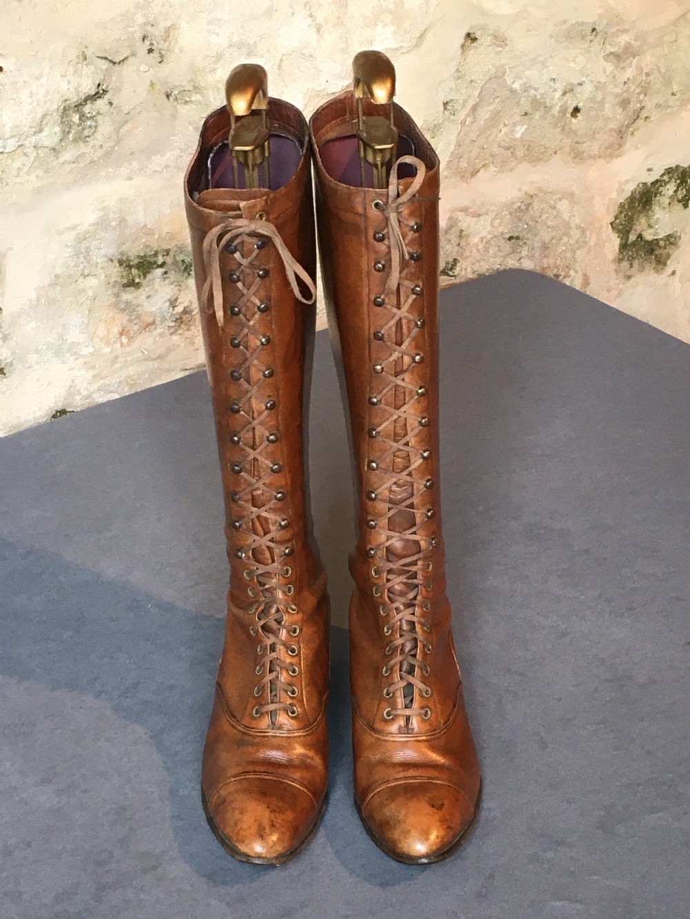 A pair of antique tall brown leather lace-up boots fitted with metal and brass boot shapers. View XIV