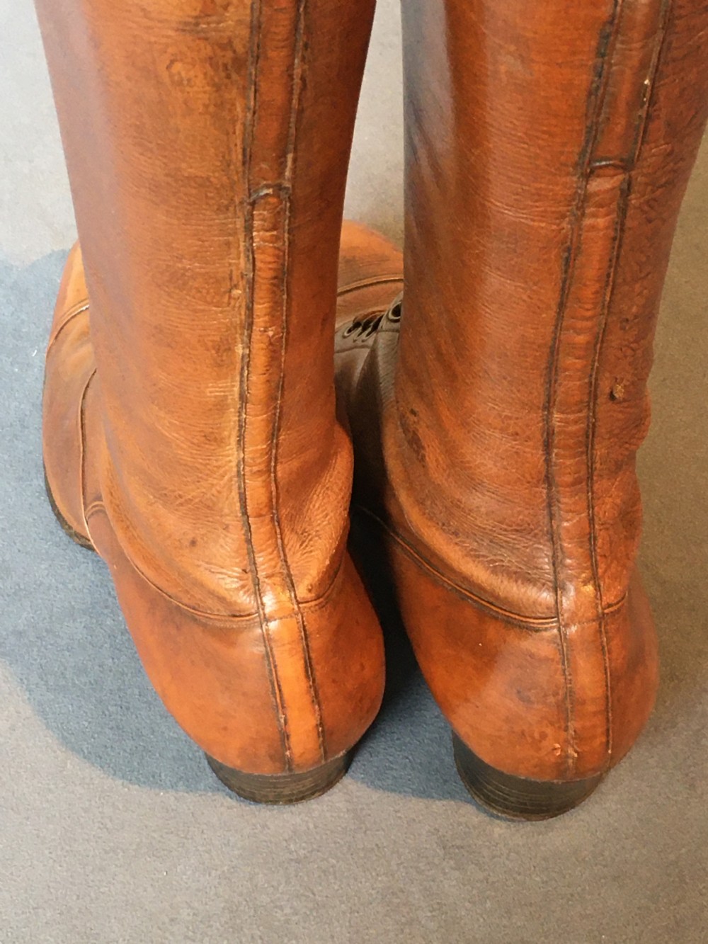 A pair of antique tall brown leather lace-up boots fitted with metal and brass boot shapers. View XVI