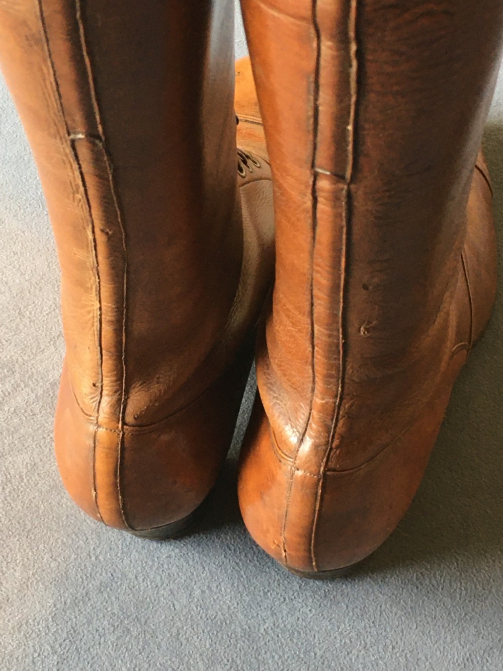 A pair of antique tall brown leather lace-up boots fitted with metal and brass boot shapers. View XVII