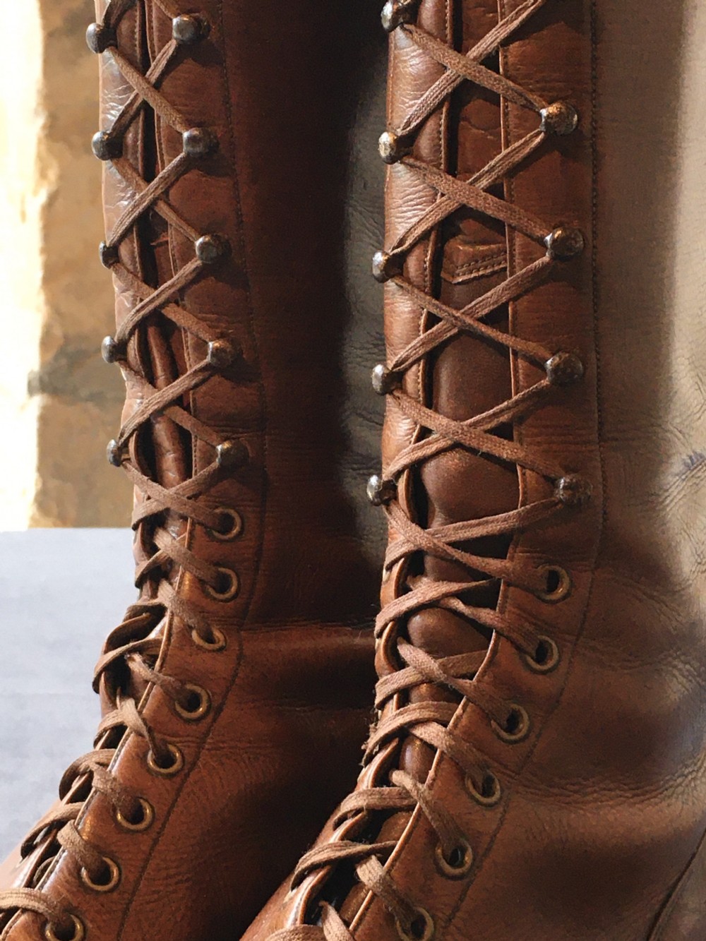 A pair of antique tall brown leather lace-up boots fitted with metal and brass boot shapers. View XVIII