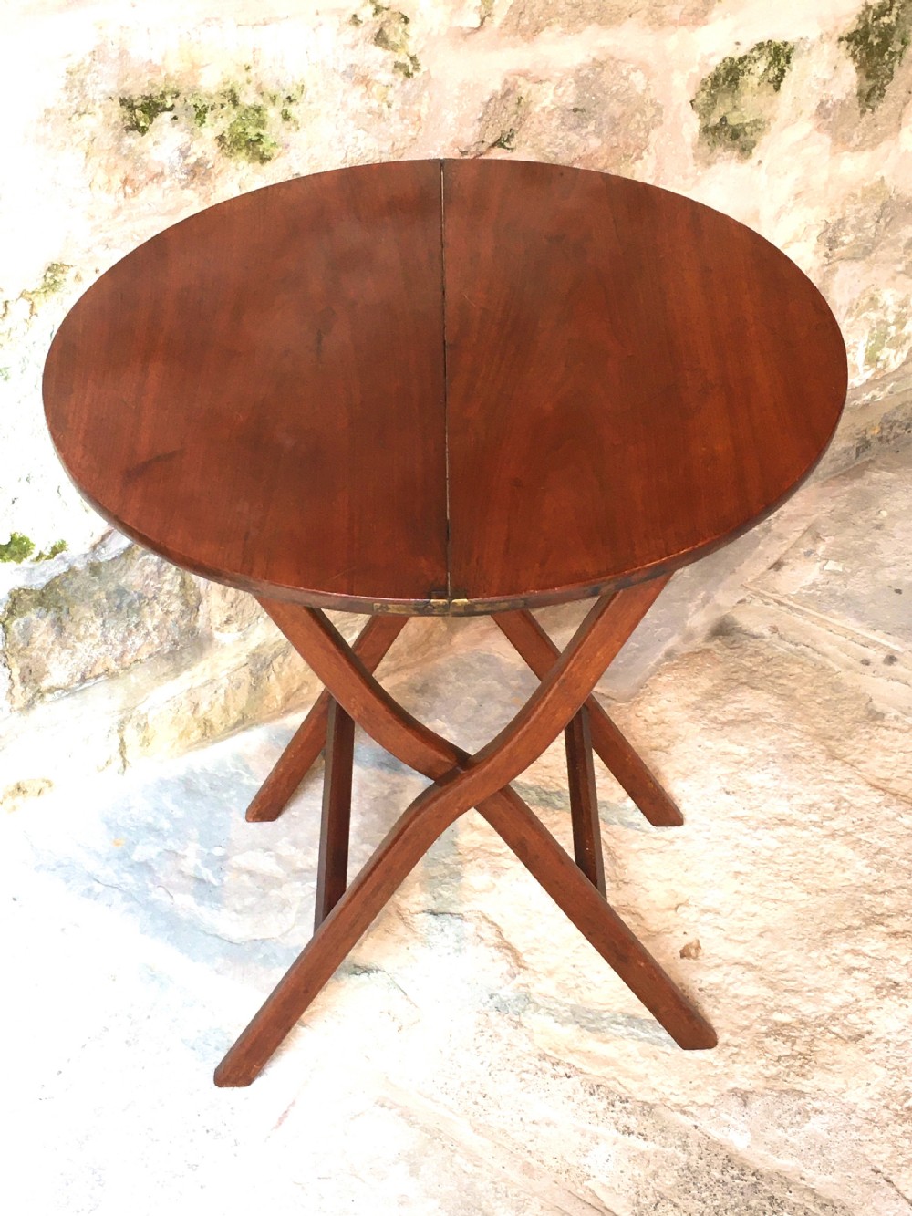 A Victorian mahogany folding occasional table with a hinged circular top supported by curved X-frame legs. View III