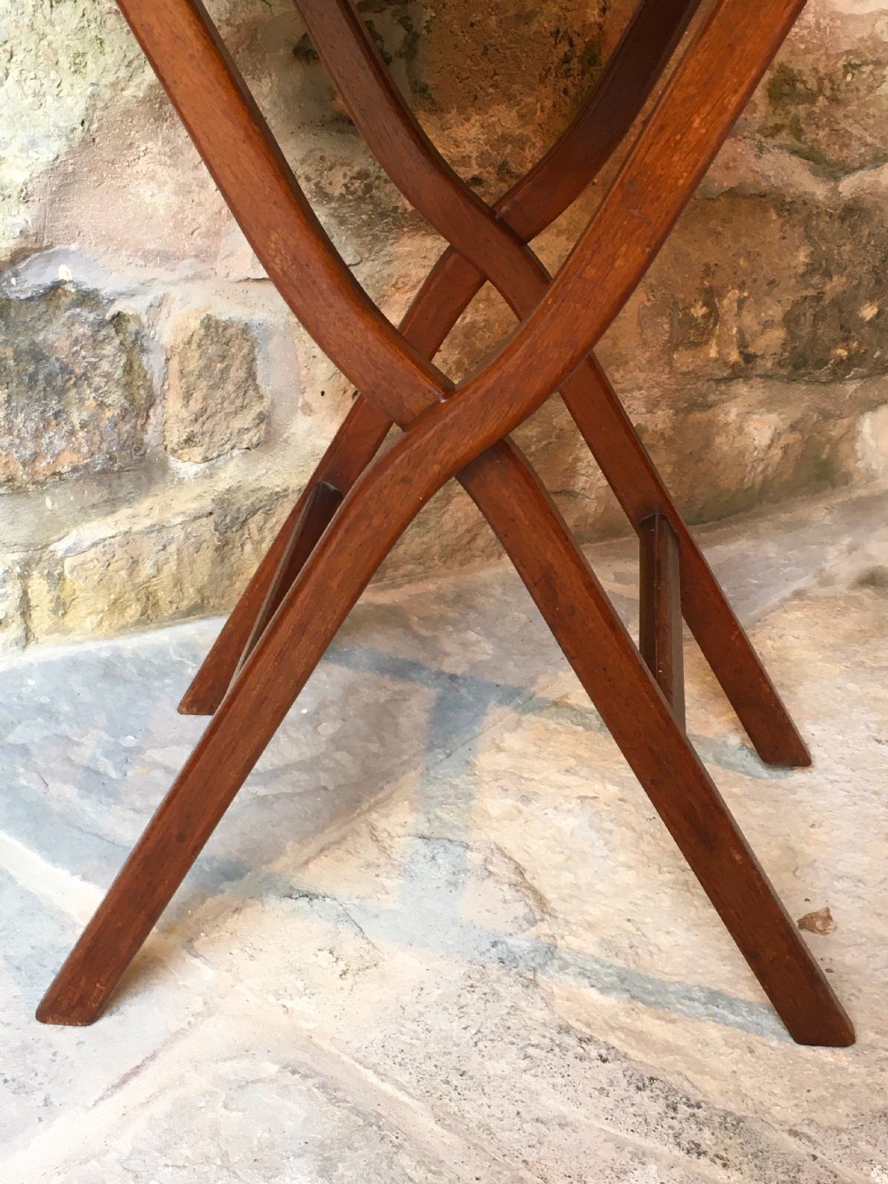 A Victorian mahogany folding occasional table with a hinged circular top supported by curved X-frame legs. View VI