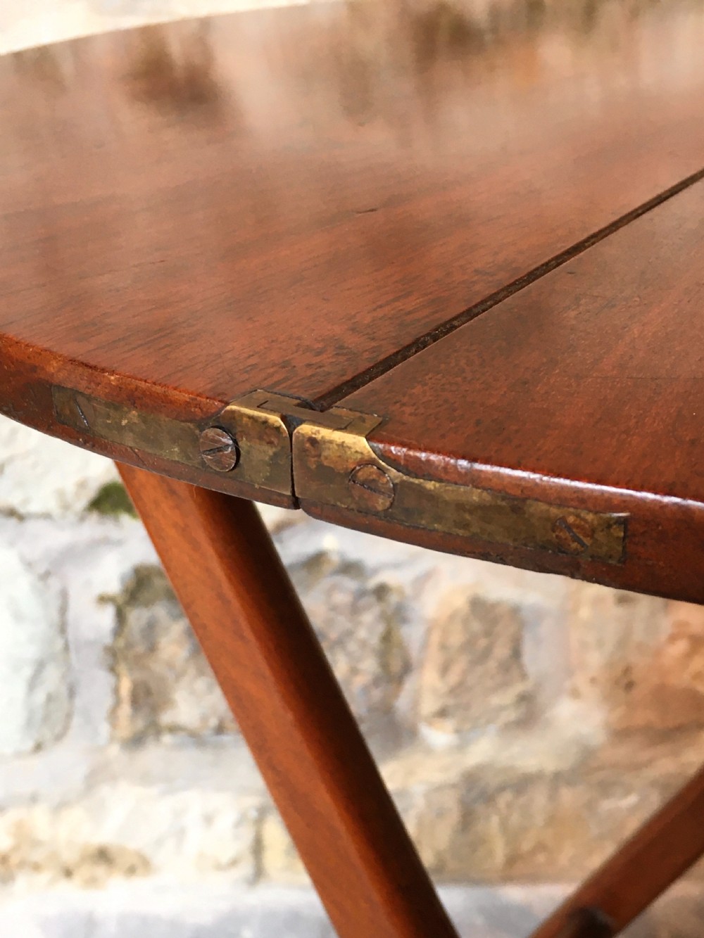 A Victorian mahogany folding occasional table with a hinged circular top supported by curved X-frame legs. View IX
