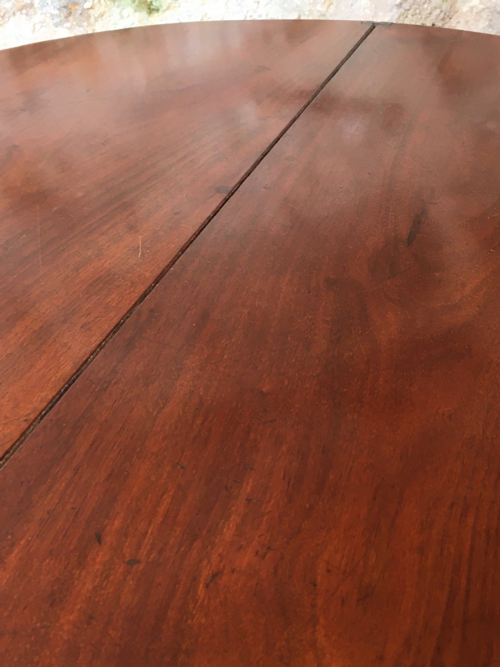 A Victorian mahogany folding occasional table with a hinged circular top supported by curved X-frame legs. View XI