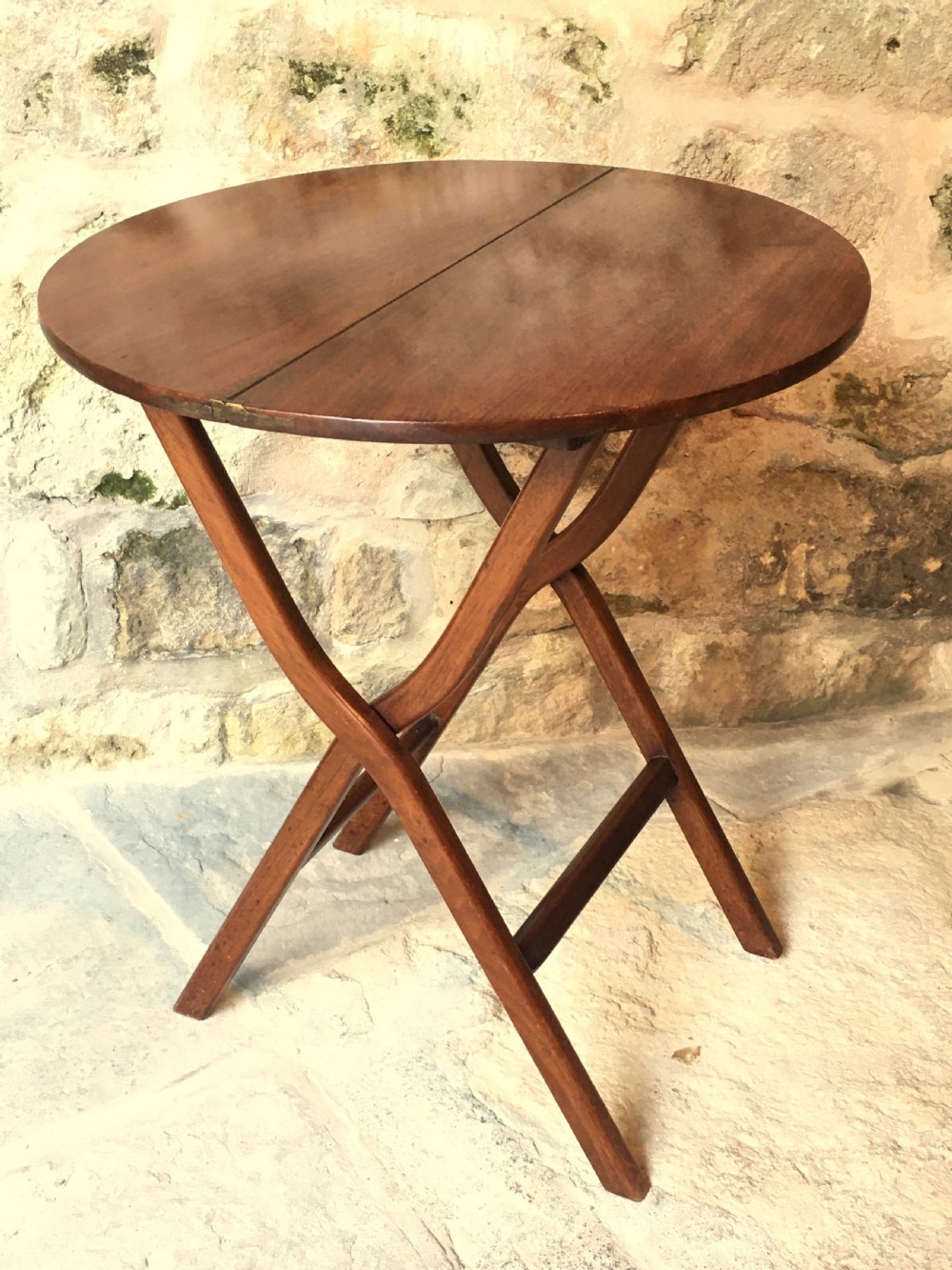 A Victorian mahogany folding occasional table with a hinged circular top supported by curved X-frame legs. View XII
