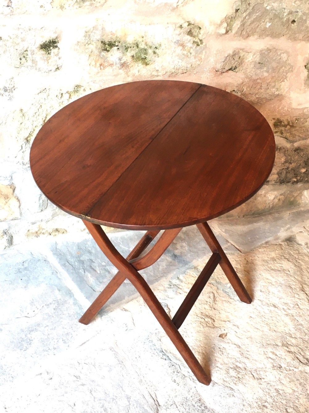 A Victorian mahogany folding occasional table with a hinged circular top supported by curved X-frame legs. View XIII