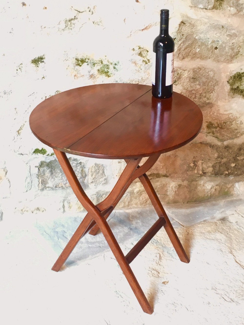 A Victorian mahogany folding occasional table with a hinged circular top supported by curved X-frame legs. View XIV