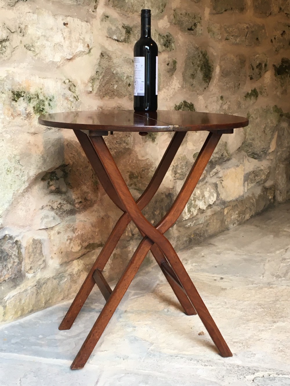 A Victorian mahogany folding occasional table with a hinged circular top supported by curved X-frame legs. View XV