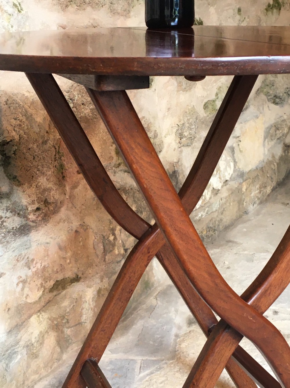 A Victorian mahogany folding occasional table with a hinged circular top supported by curved X-frame legs. View XVII