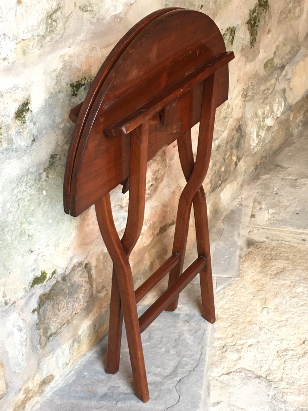 A Victorian mahogany folding occasional table with a hinged circular top supported by curved X-frame legs. View XVIII