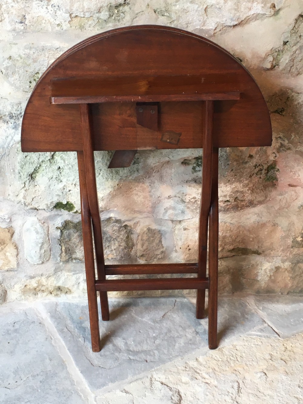 A Victorian mahogany folding occasional table with a hinged circular top supported by curved X-frame legs. View XIX