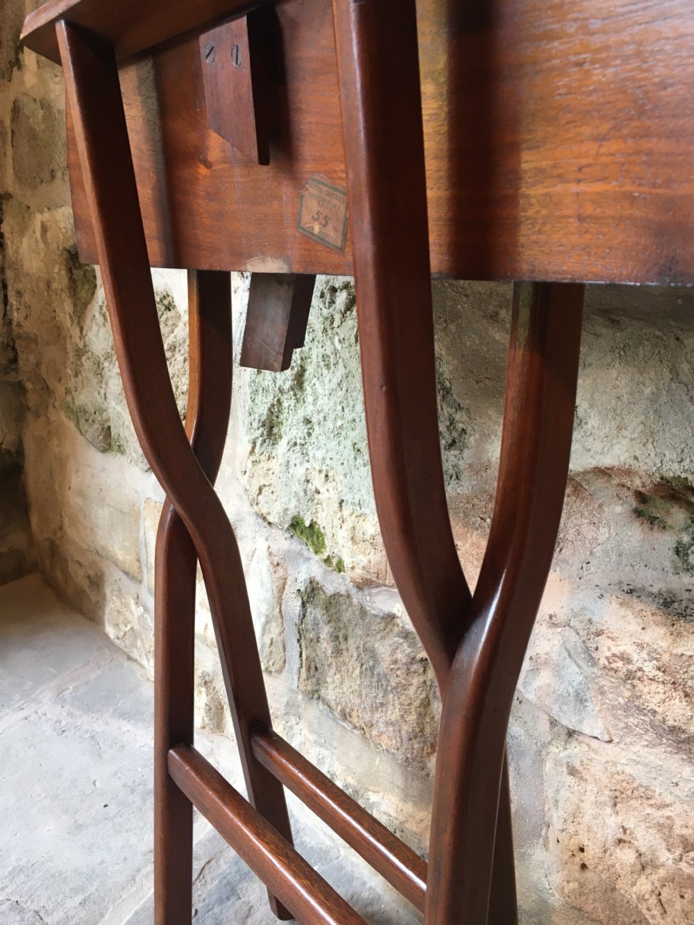 A Victorian mahogany folding occasional table with a hinged circular top supported by curved X-frame legs. View XXIII