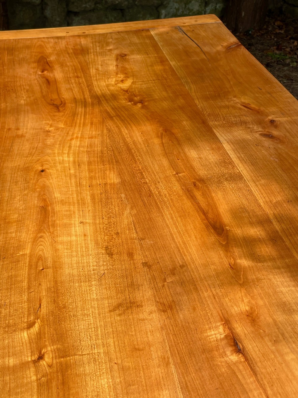 A rectangular wooden refectory dining table with a plank top, breadboard ends, and four tapered legs. View VII