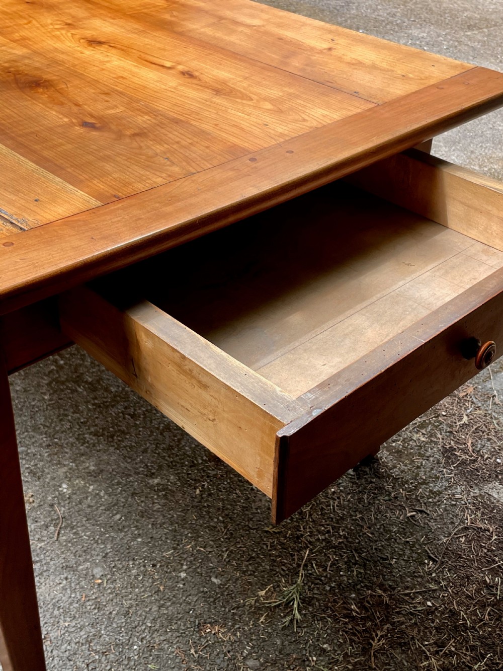 A rectangular wooden refectory dining table with a plank top, breadboard ends, and four tapered legs. View XII