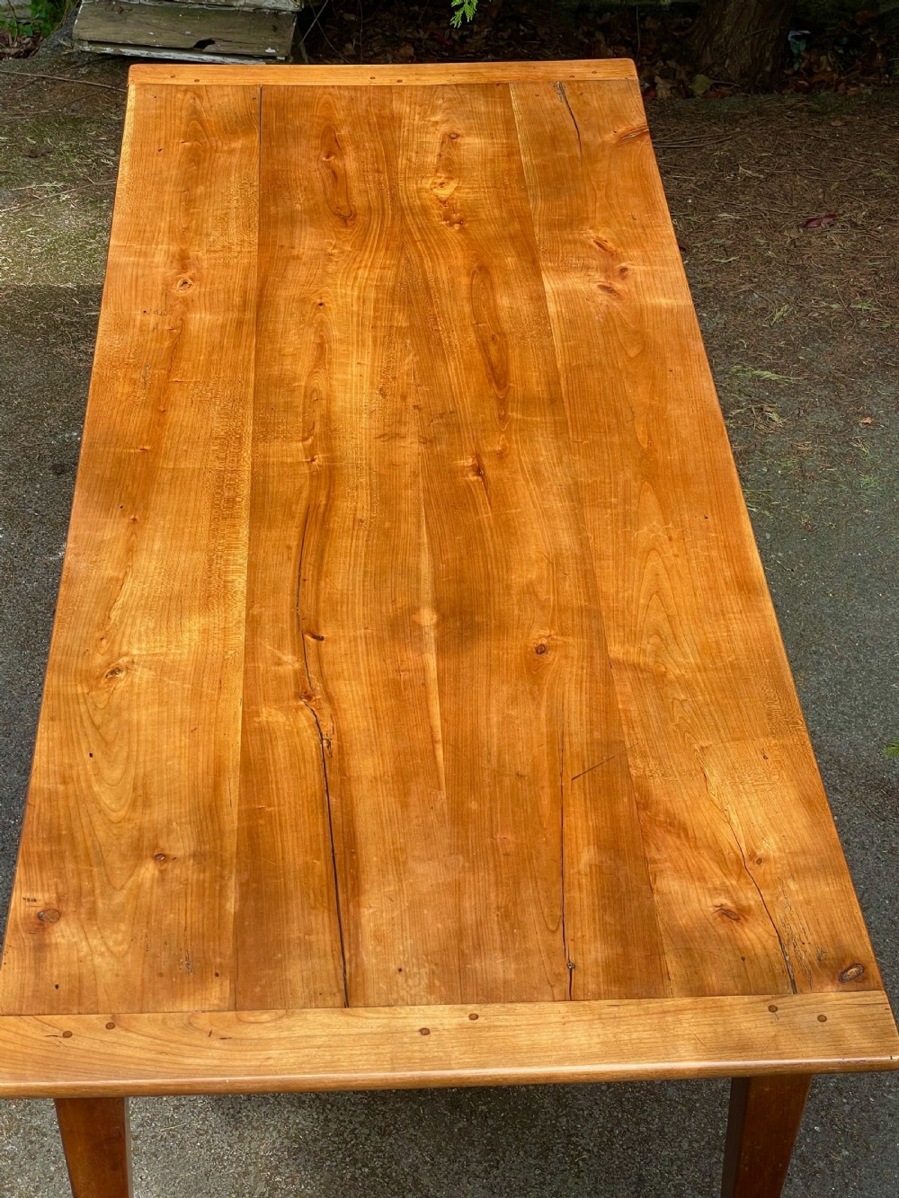 A rectangular wooden refectory dining table with a plank top, breadboard ends, and four tapered legs. View XIV