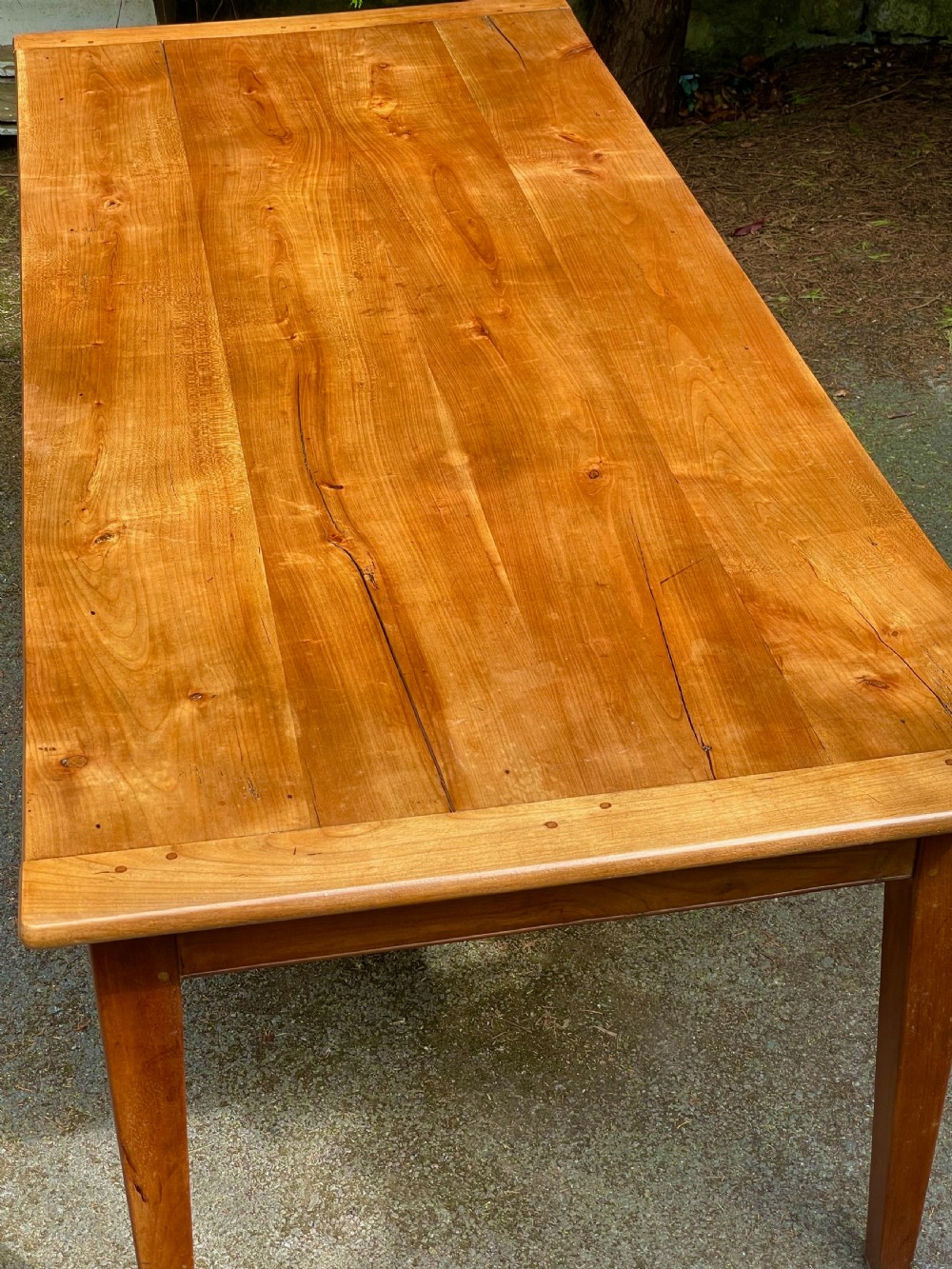 A rectangular wooden refectory dining table with a plank top, breadboard ends, and four tapered legs. View XV