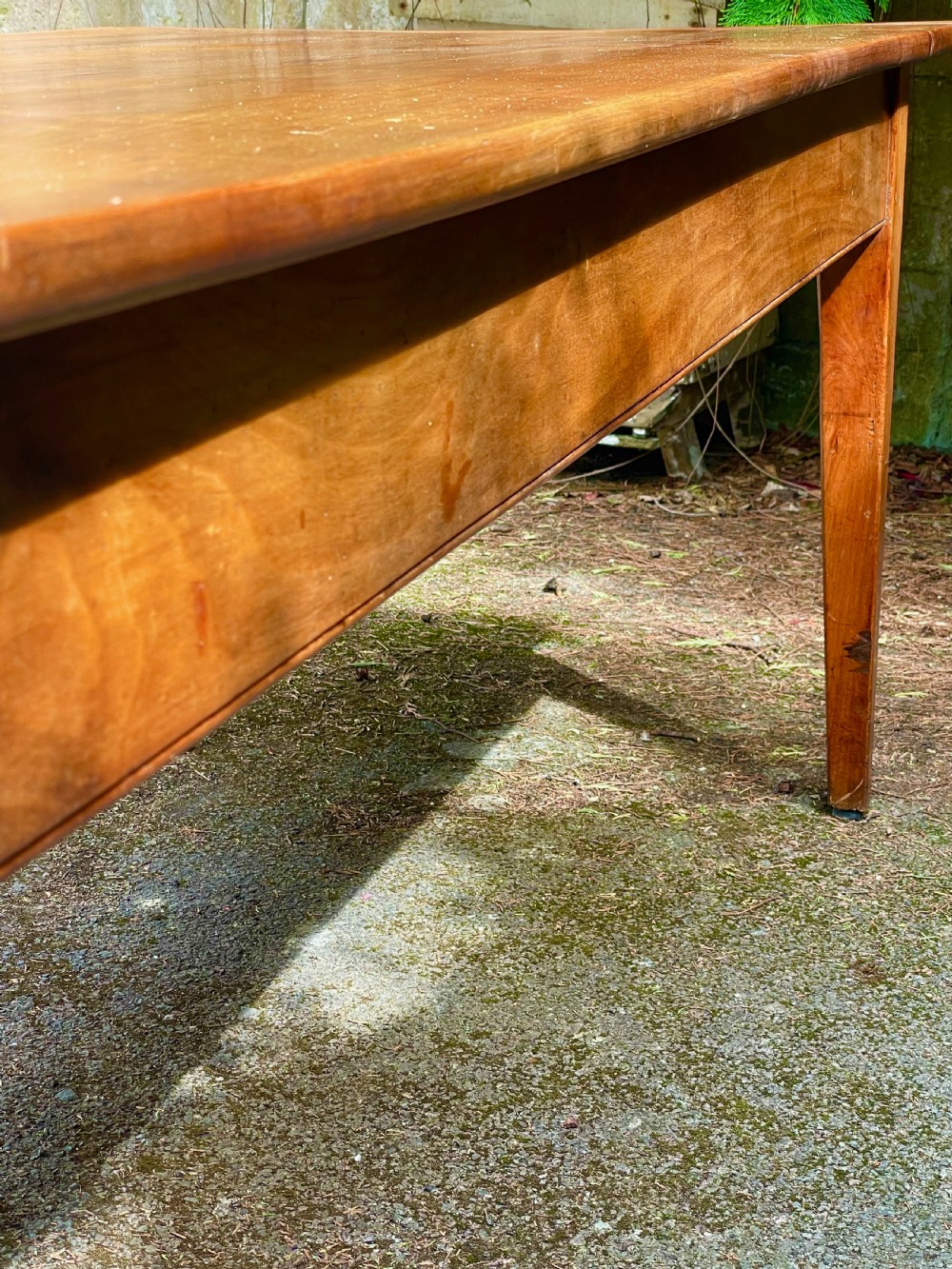 A rectangular wooden refectory dining table with a plank top, breadboard ends, and four tapered legs. View XVI