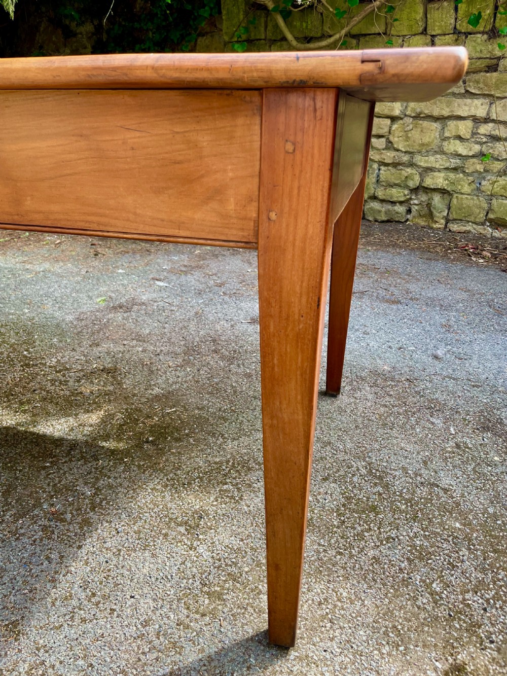 A rectangular wooden refectory dining table with a plank top, breadboard ends, and four tapered legs. View XVIII