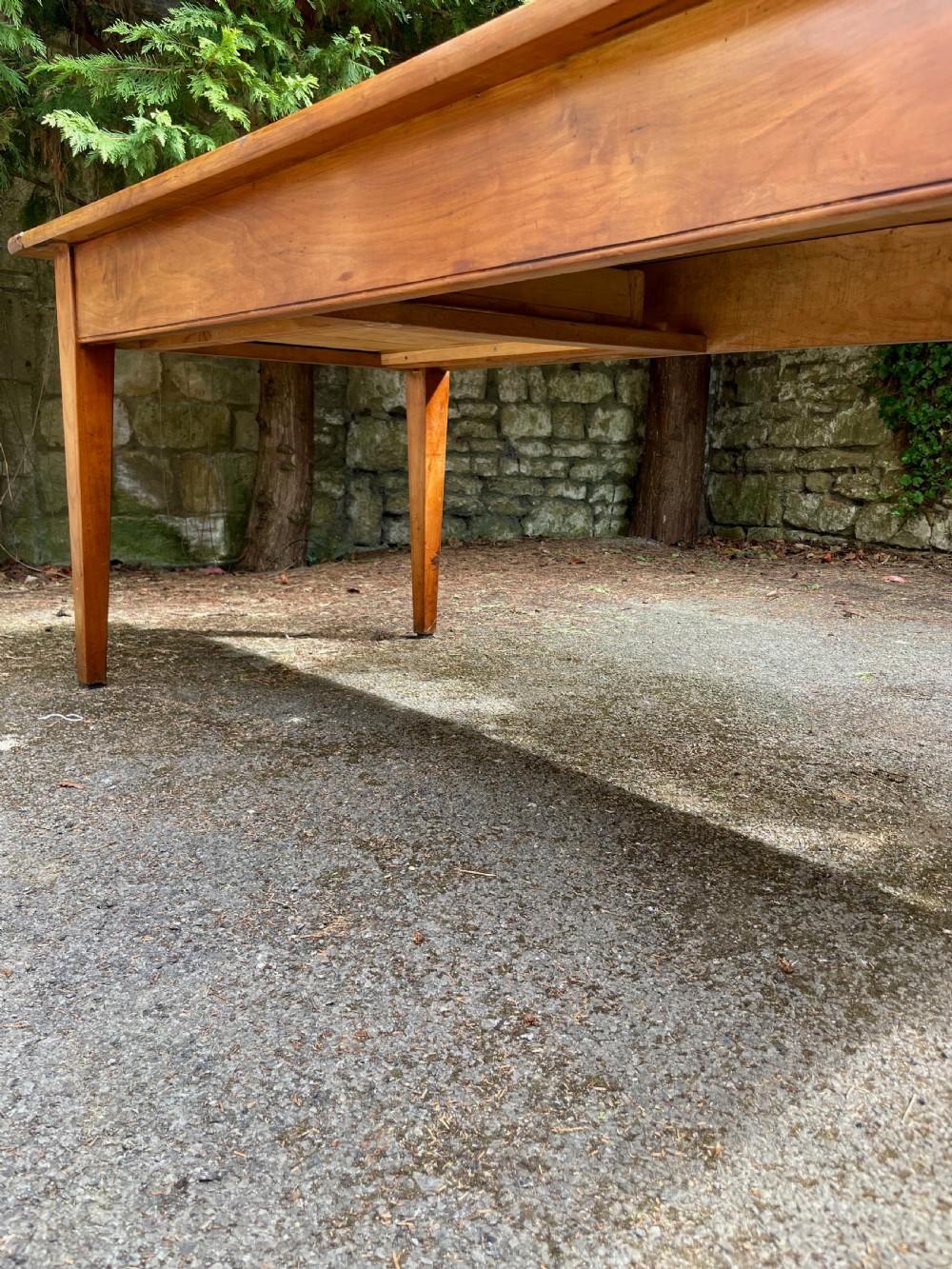 A rectangular wooden refectory dining table with a plank top, breadboard ends, and four tapered legs. View XIX