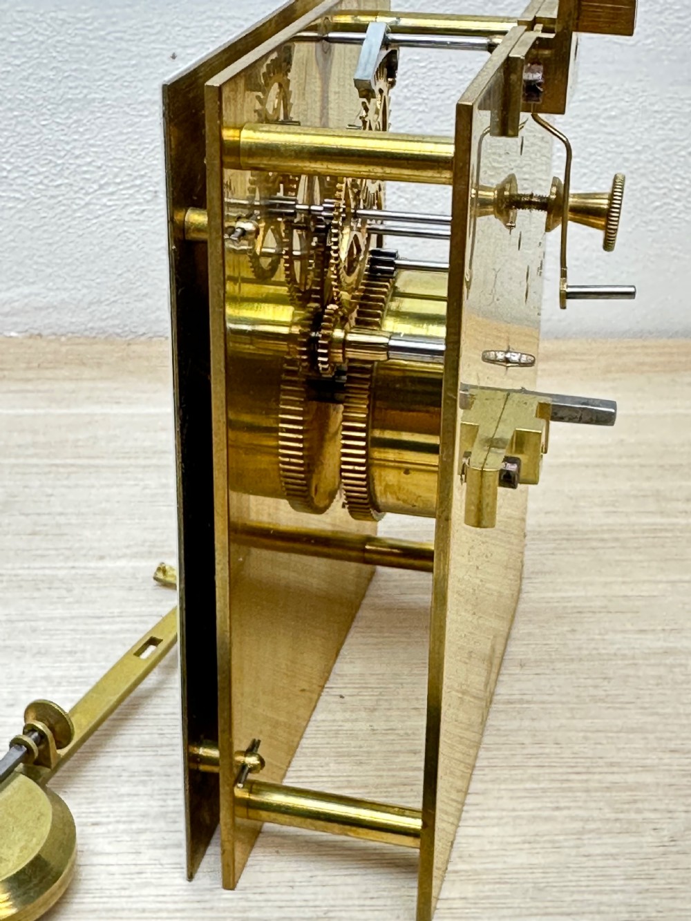 A rectangular dark rosewood mantel clock featuring an enamel dial with Roman numerals surrounded by decorative brass spandrels. View VIII