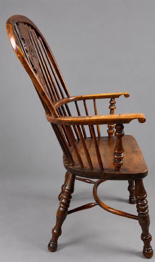 An antique high-back yew wood Windsor armchair featuring turned legs, a shaped seat, and a central pierced fretwork splat. View VI